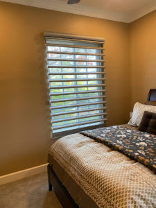 bedroom with bed and shades